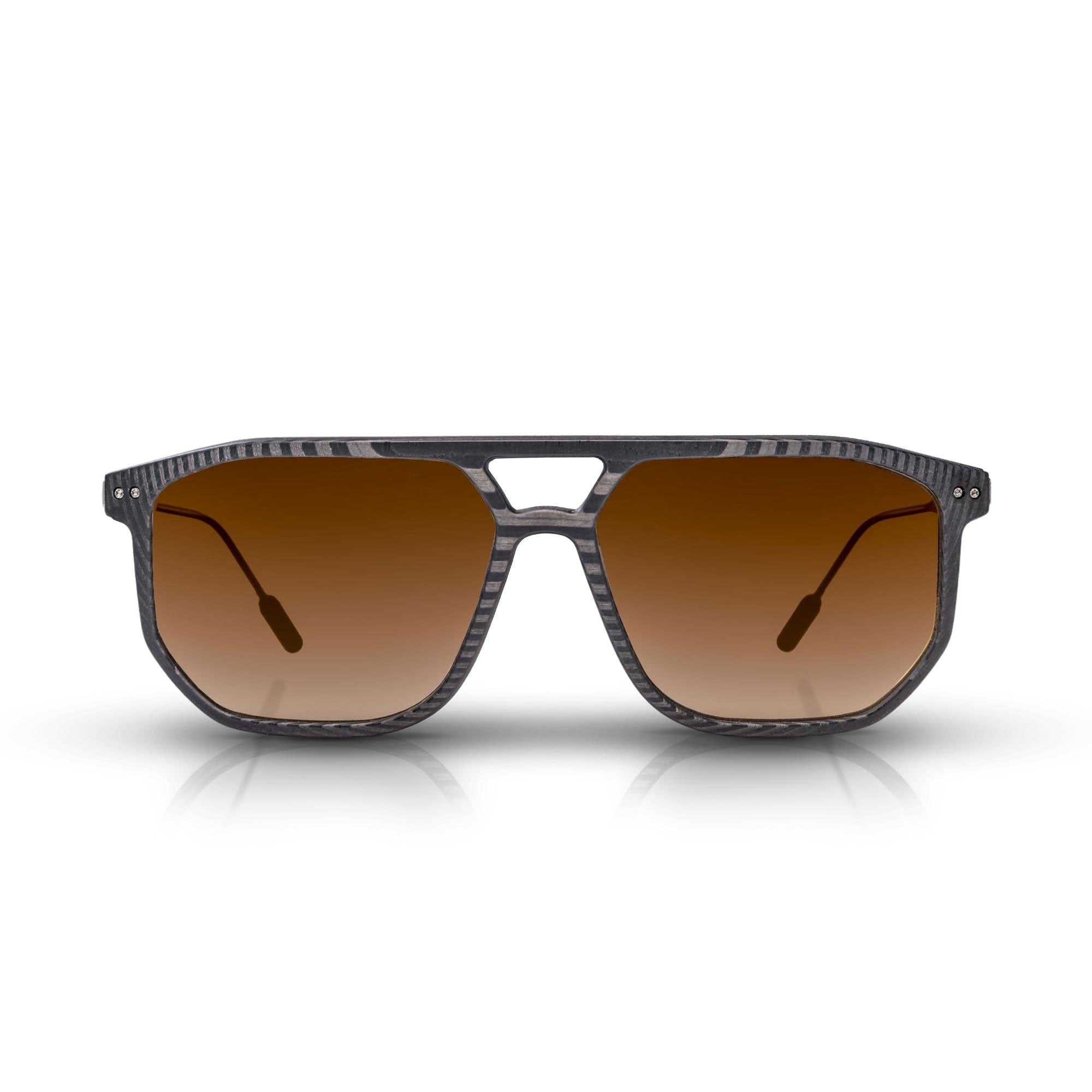 Front of the latest Roveri Eyewear The Sterling Bronze from the latest Gunther Werks Collection, vintage squared Pilot inspired sunglasses for men in UDCT® Machined Carbon Fiber, with light blue gradient lenses and satin Beta-Titanium frame, handmade in Italy.